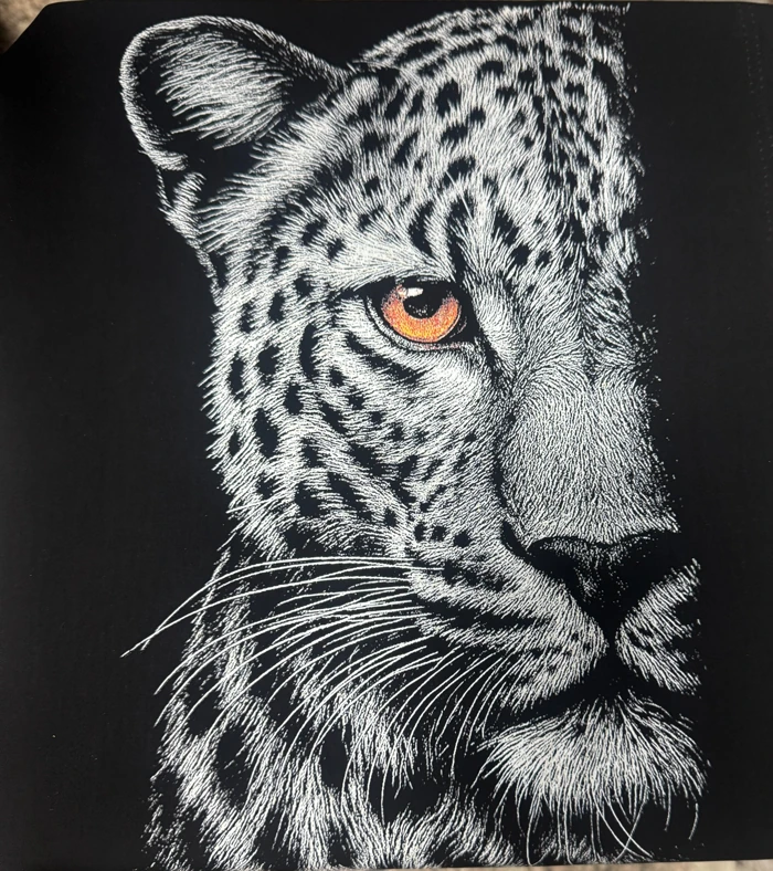 Leopard DTF print close-up with fine white fur lines and an orange eye
